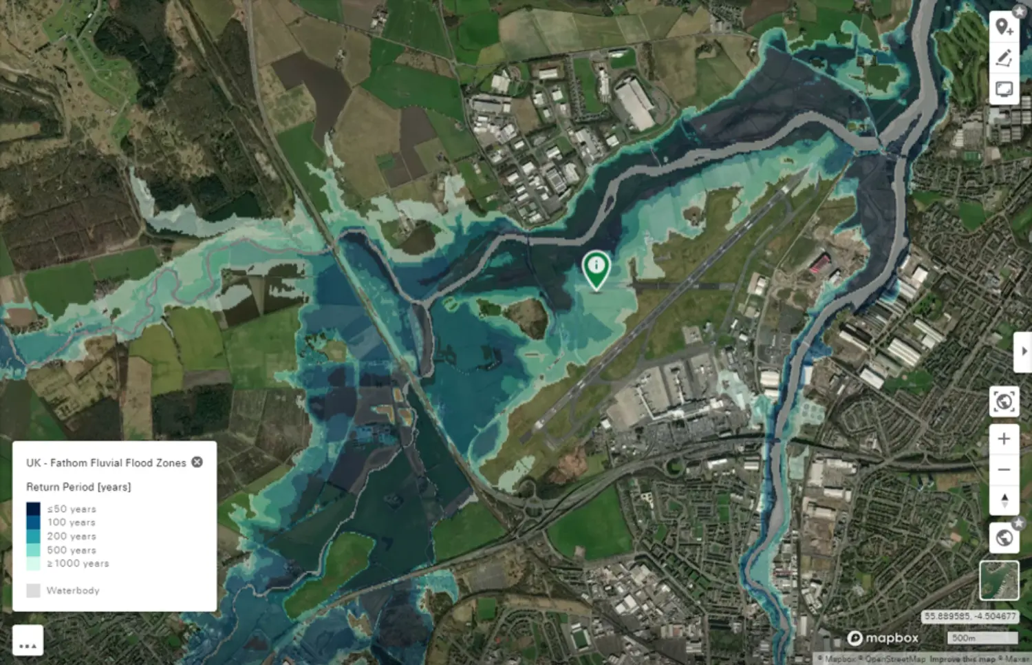 Aerial view of a UK neighborhood with a tranquil canal, surrounded by lush nature and open sea, visualized on a business card.