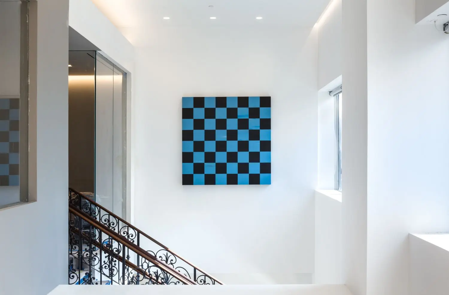 Sarah Ortmeyer has created an oversized chess-board mural on the wall adjacent to the stairwell on the 45th floor.