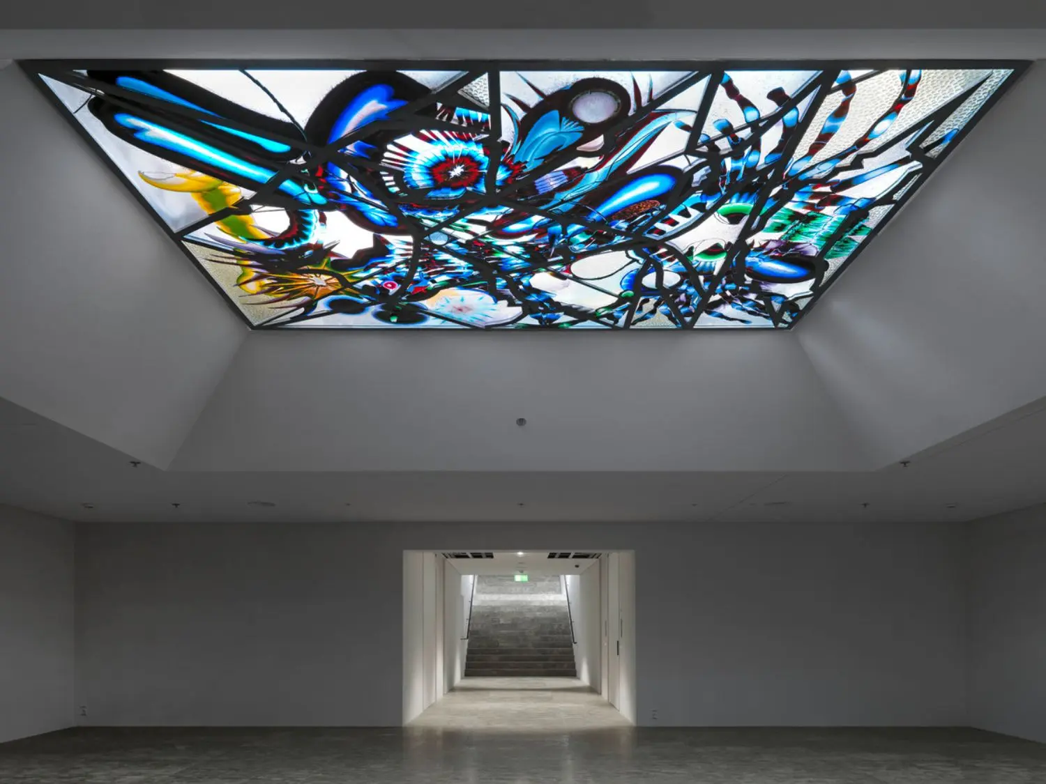 The glass of the window seems to succumb to gravity, almost dripping out of its aluminium frame.