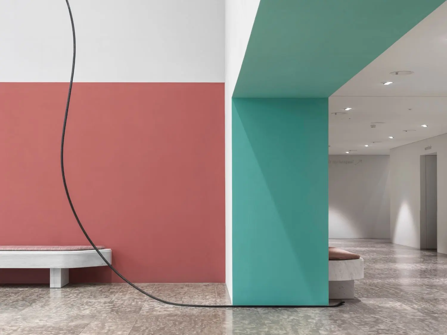 Long, elegant wrought-iron snake in the foyer outside the auditorium at Swiss Re Next.