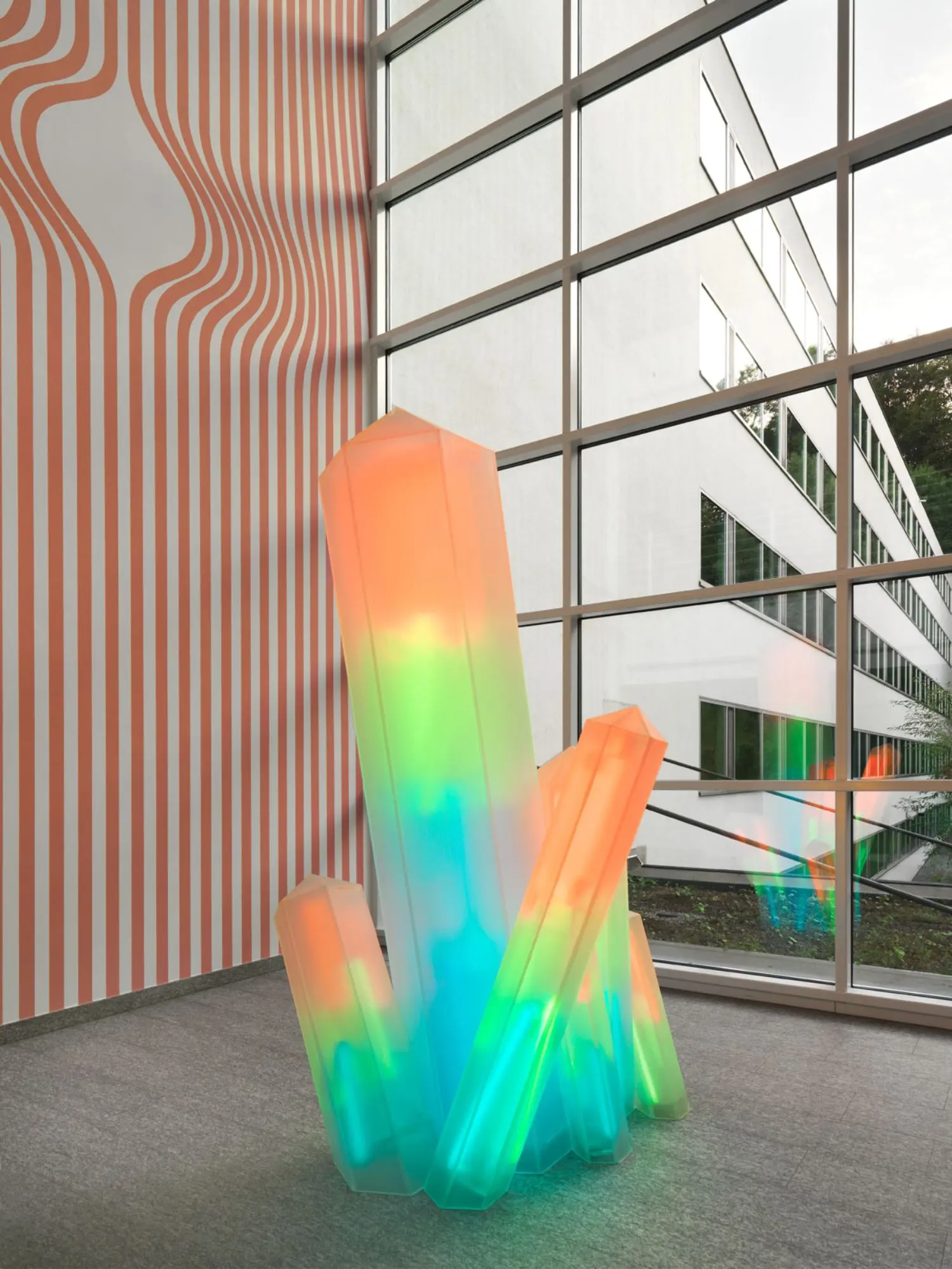 A striped pink and purple wall painting provides the vibrant and lively setting for Fleury's companion piece.